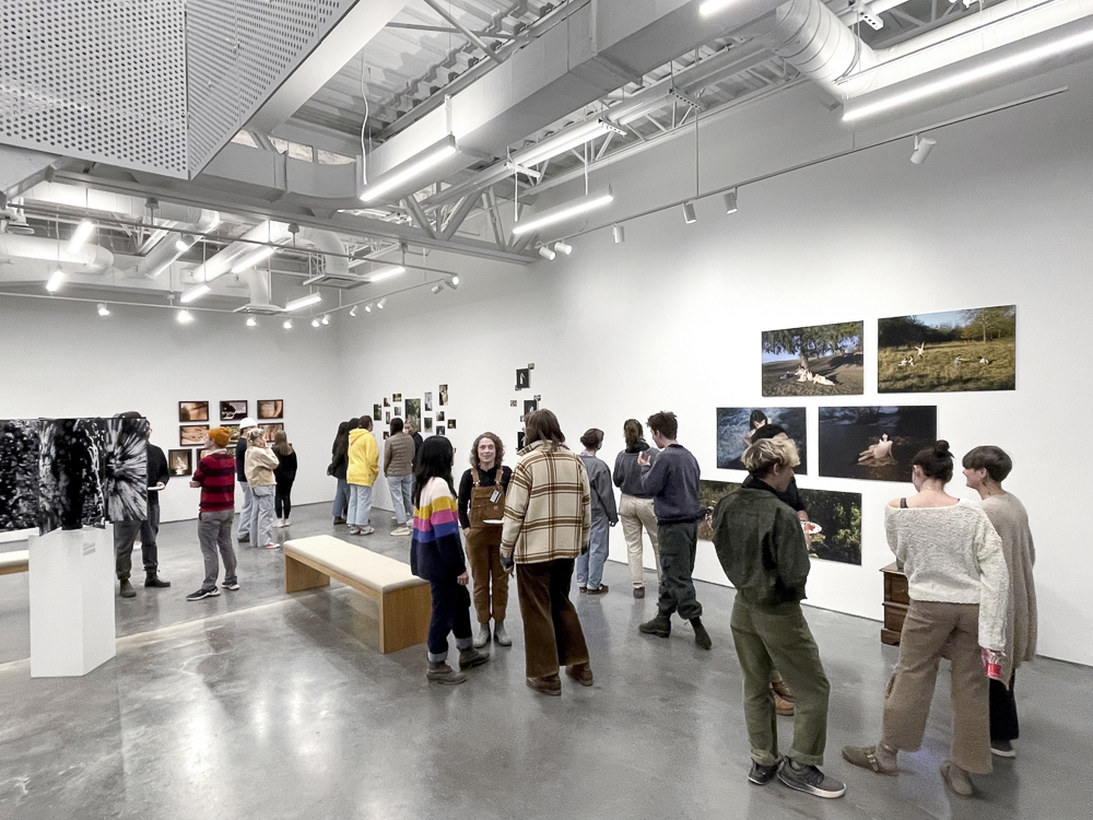 Photography students in a gallery